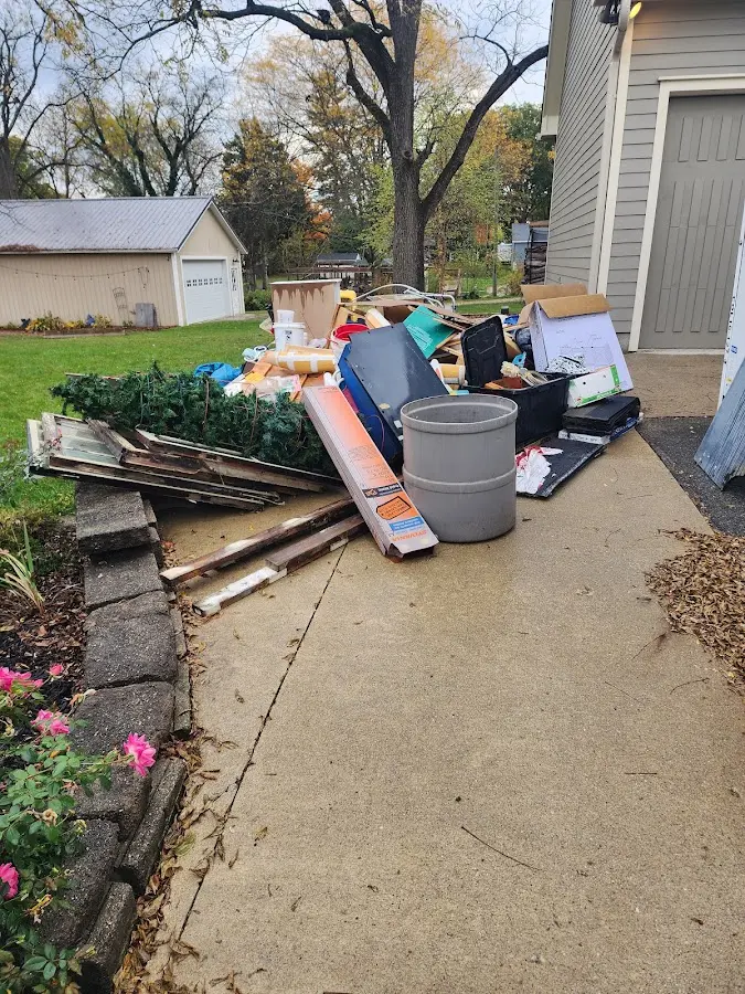 Dumpster being loaded with debris for 12 Yard Dumpster Rental in Bothell West